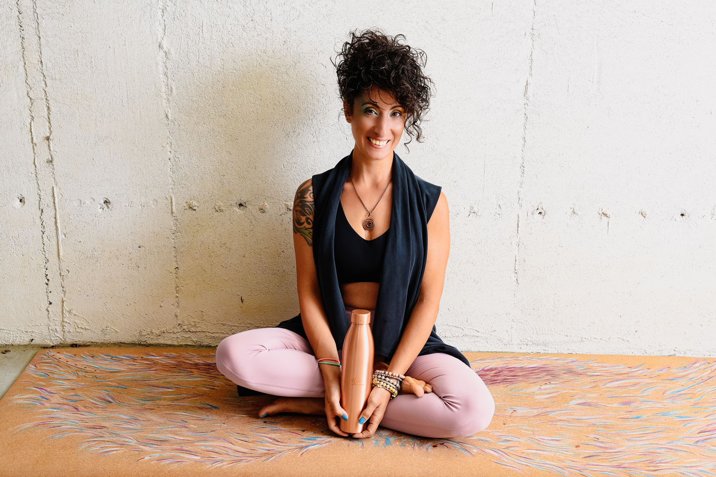 CEO and founder of ilaSTRATE yoga mat company. Featuring lotus pose on khecara angel wings hand painted cork yoga mat.