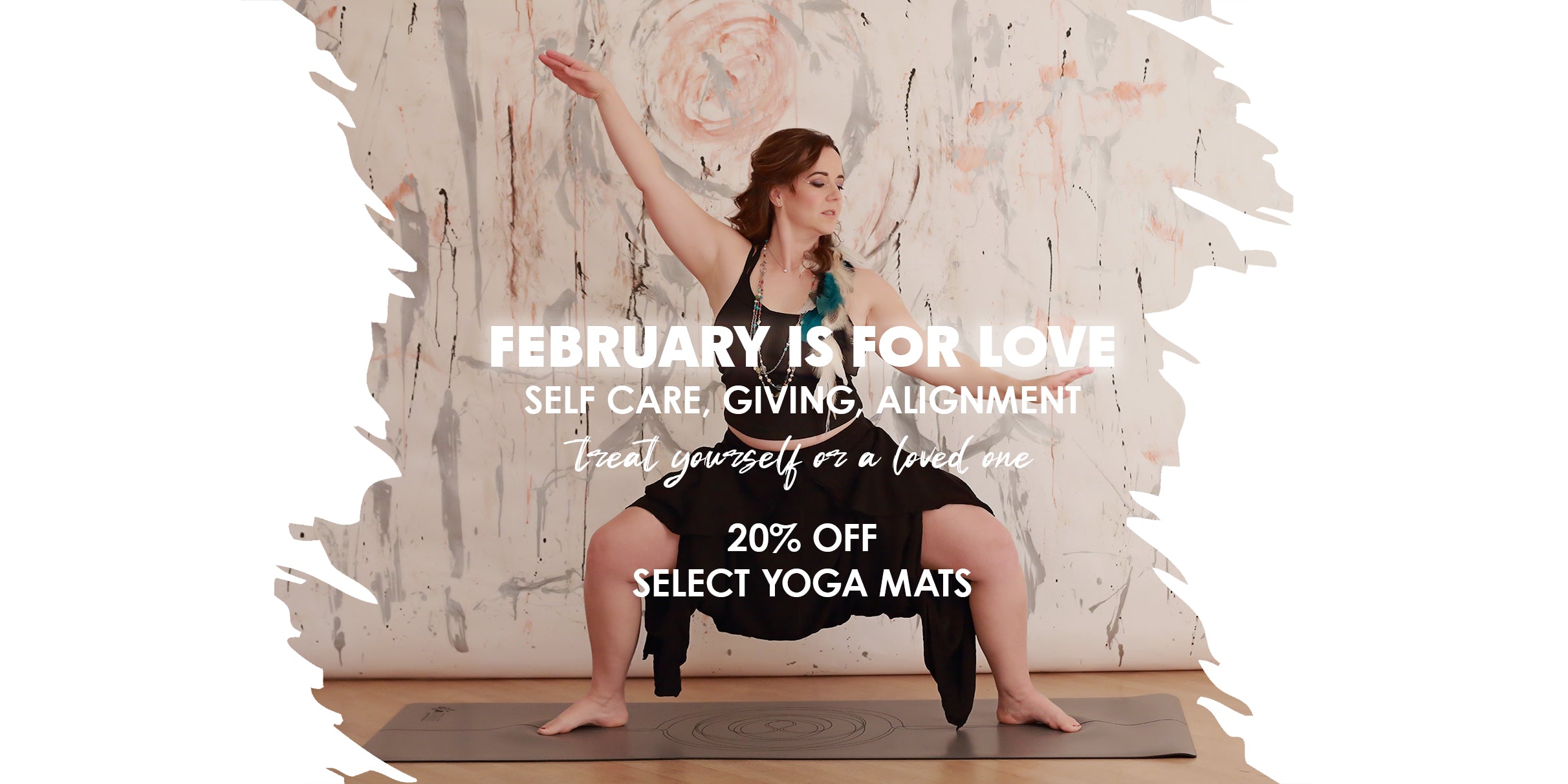 woman in goddess yoga pose on grey yoga mat, feathers in her hair, with art background. text overlay ad for ilaSTRATE february promotions overlay "february is for love. self care, giving, alignment. treat yourself or a love one. 20% off select yoga mats."